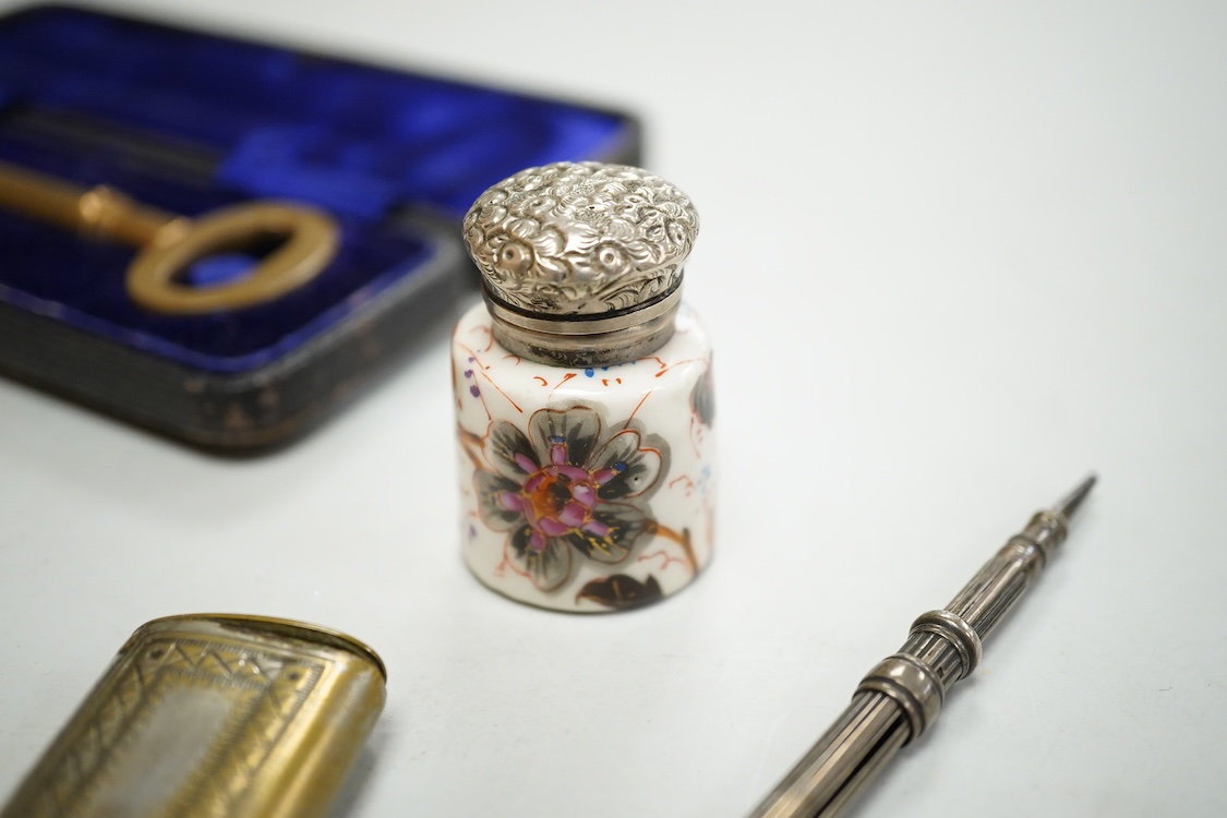 A collection of sundry items to include a large cased key, novelty lighter in the form of a shoe and a citrine set propelling pencil